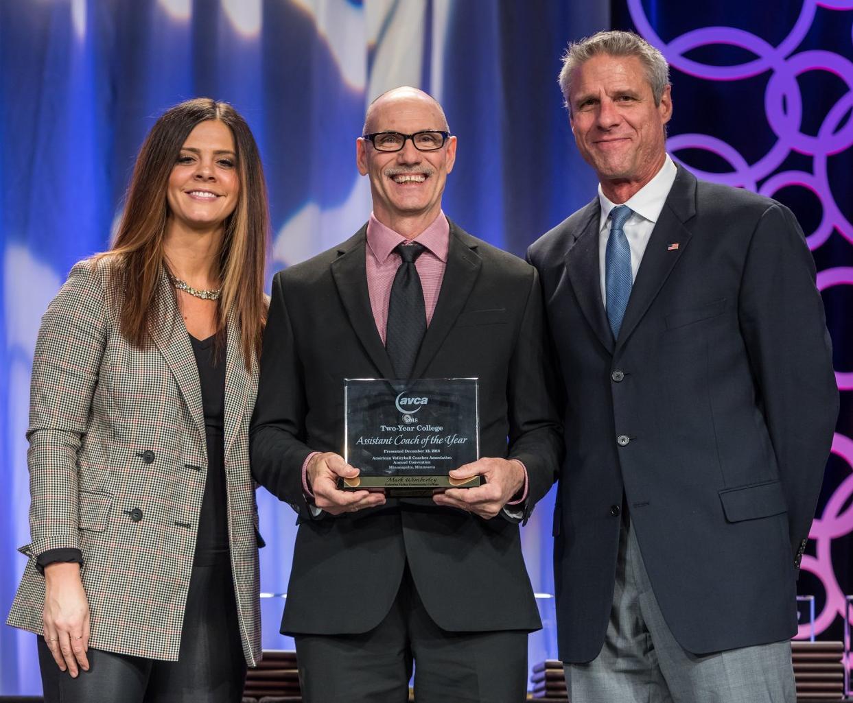 Wimberley receives his AVCA Two-Year National Assistant Coach of the Year award.